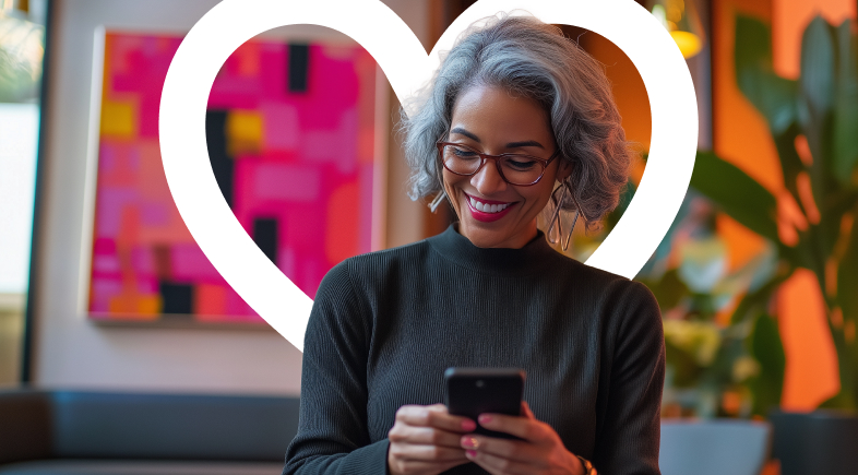 Woman on phone with heart icon behind her.